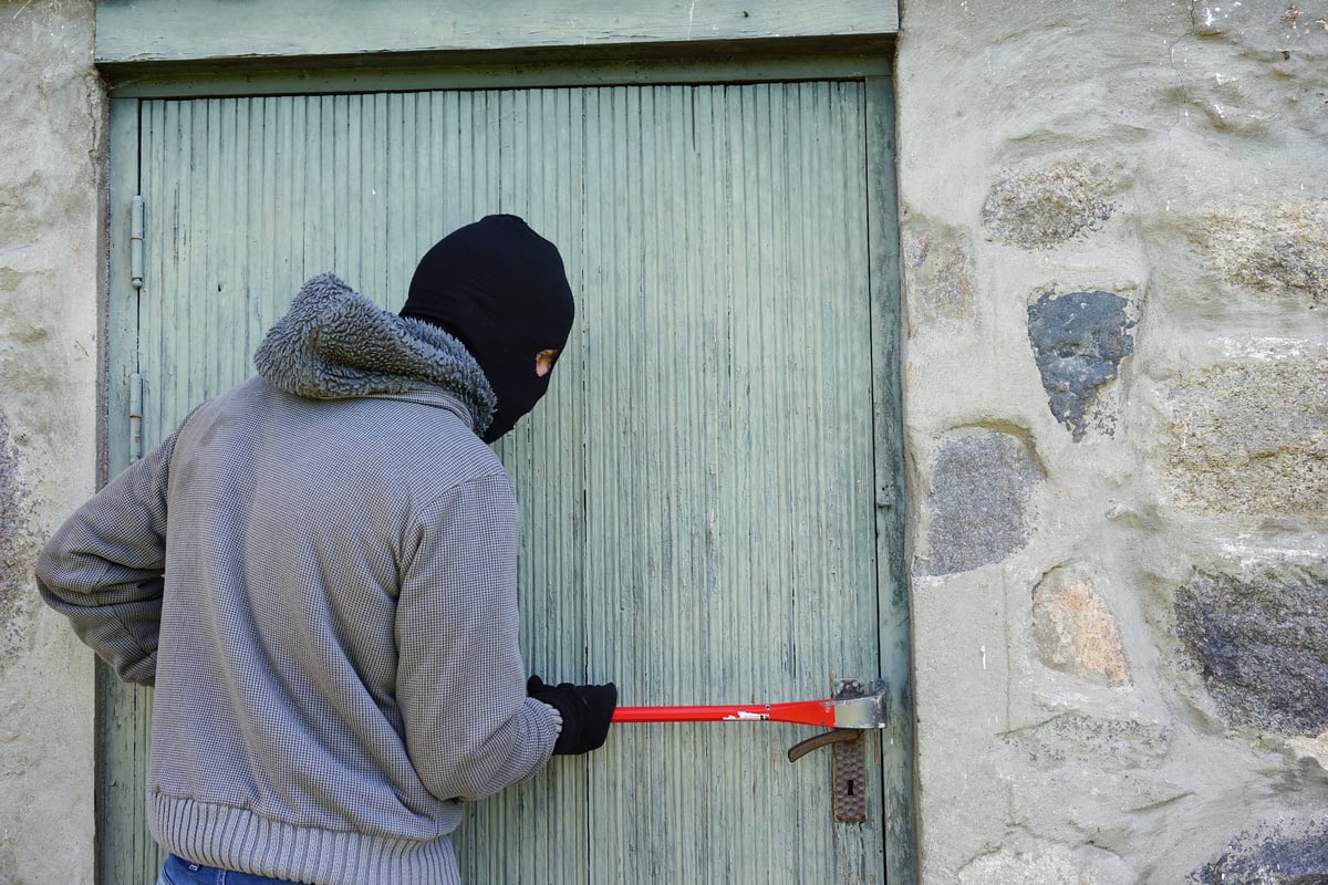 Thief Trying to Break into a House