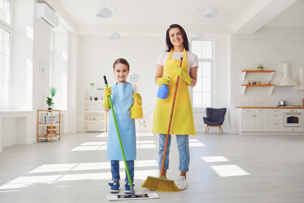 Clean Washing Home.Mother and Girl Kid Clean the Living Room.